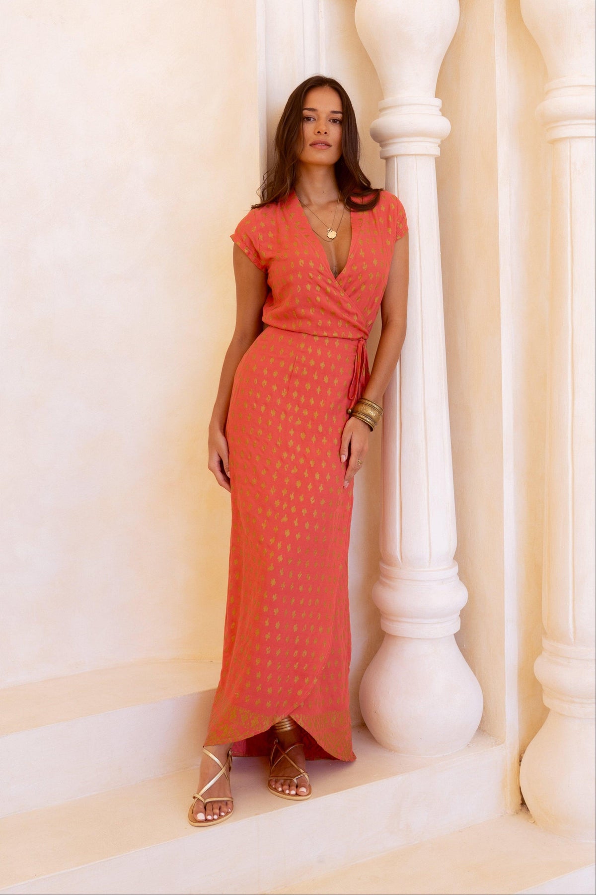 Vivid coral and shimmering gold wrap dress